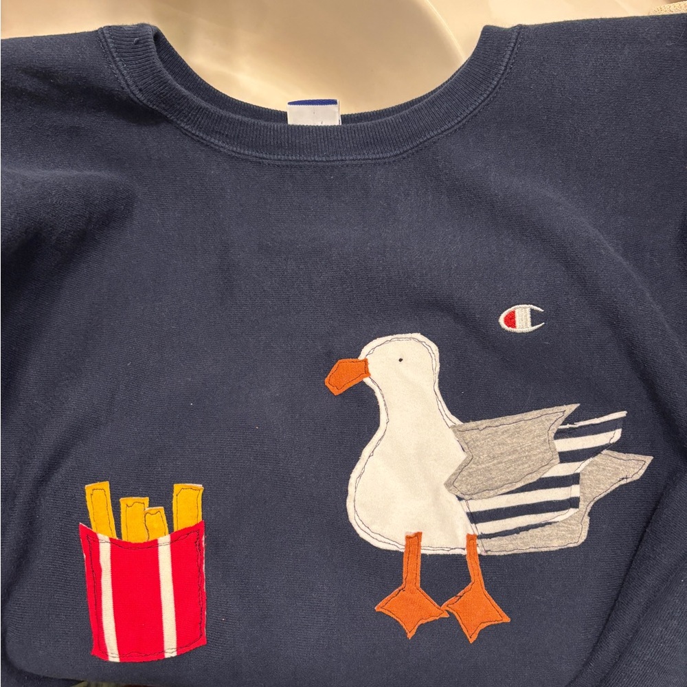 Champion Blue Sweatshirt with Seagull and Fries Design